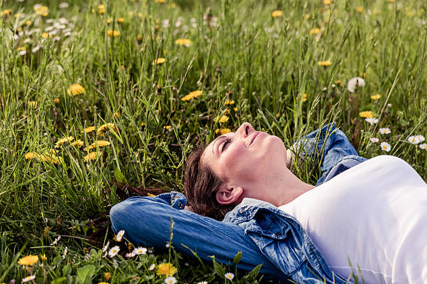 istock Happy Woman relaxing in a park 181897308