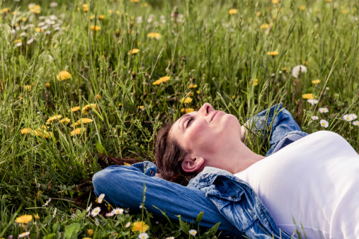 beautiful girl lying down of grass. Copy space.