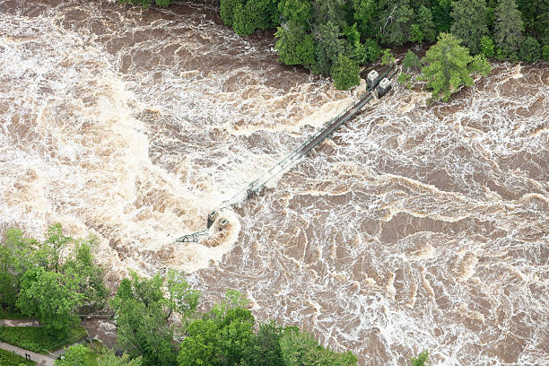 istock Muddy River Overflowing Banks with Washed Out Footbridge 181897482