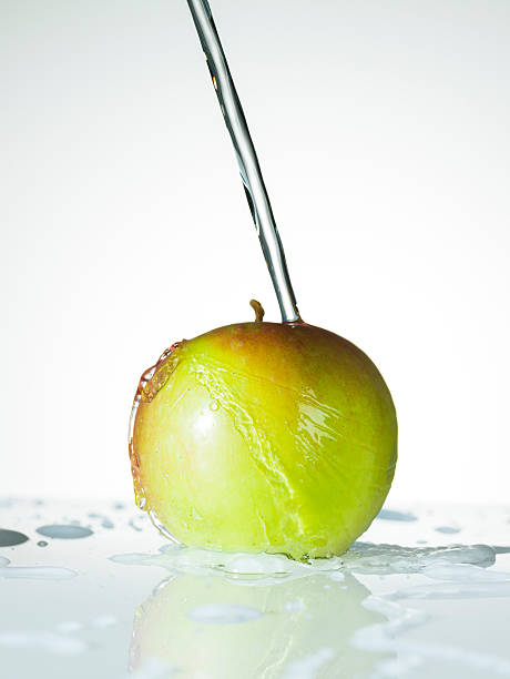 Water Splashing on a Fresh Green Apple