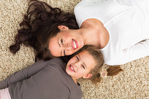 istock Mother and daughter lying on the floor 181898069