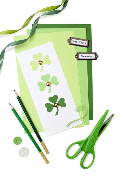 "Assorted tools and materials for scrapbooking or card making. Pure white background, soft shadows."