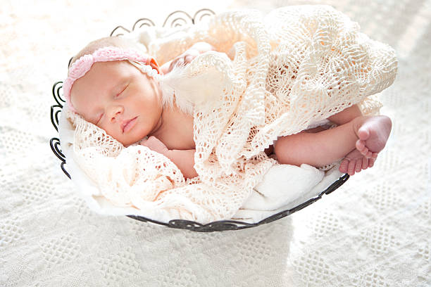 istock Sleeping Newborn Baby with Headband in Basket 181898763
