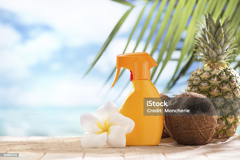 Suntan lotion, coconuts and plumeria flower with copy space "Suntan lotion, coconuts, pineapple and plumeria flower with copy space" Coconut Stock Photo