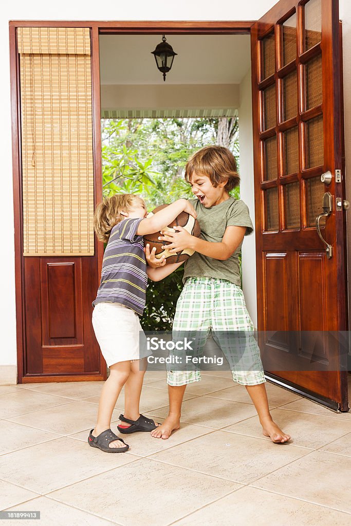 Two brothers fighting over a ball Two brothers fighting over a ball.Please browse: Arguing Stock Photo