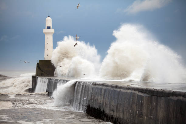 Storm waves striking the Aberdeen harbour breakwater, Scotland "North Sea waves breaking against the wall at the entrance to Aberdeen Harbour, Scotland.Related Image (Main Collection):" north sea waves stock pictures, royalty-free photos & images