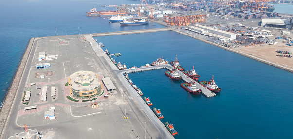 Jeddah Islamic Seaport aerial view with moored tugs and pilot boats