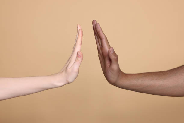 istock International relationships. People giving high five on light brown background, closeup 1819000054