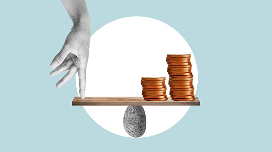 Balance of finances is shown with collage with hand and coins on wooden seesaw. Stacks coins, maintaining balance of economy, controlling the price, controlling the economy, balance of finances