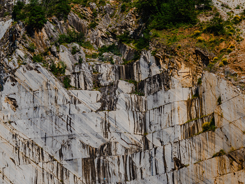 Large blocks of marble partly cut out of the Apuan Alps in one the quarries near Carrara, Italy