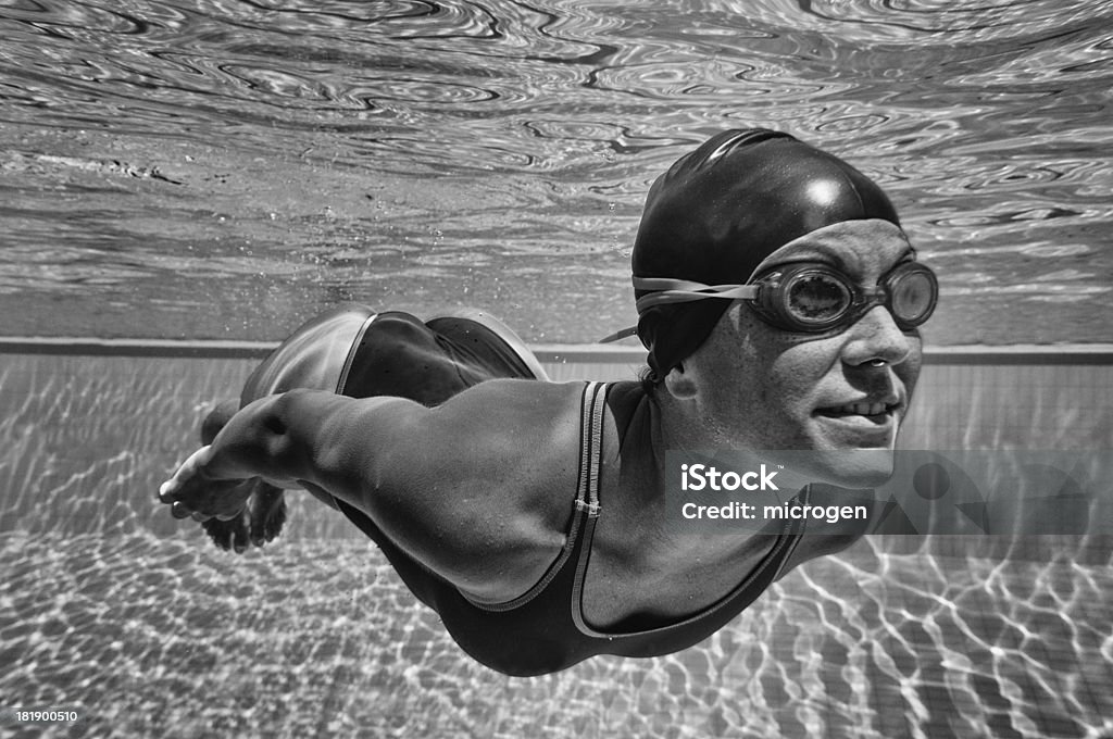 Retro underwater swimmer "Young woman swimming underwater. Retro style black and white processing, increased contrasts, very fine grain added" Retro Style Stock Photo