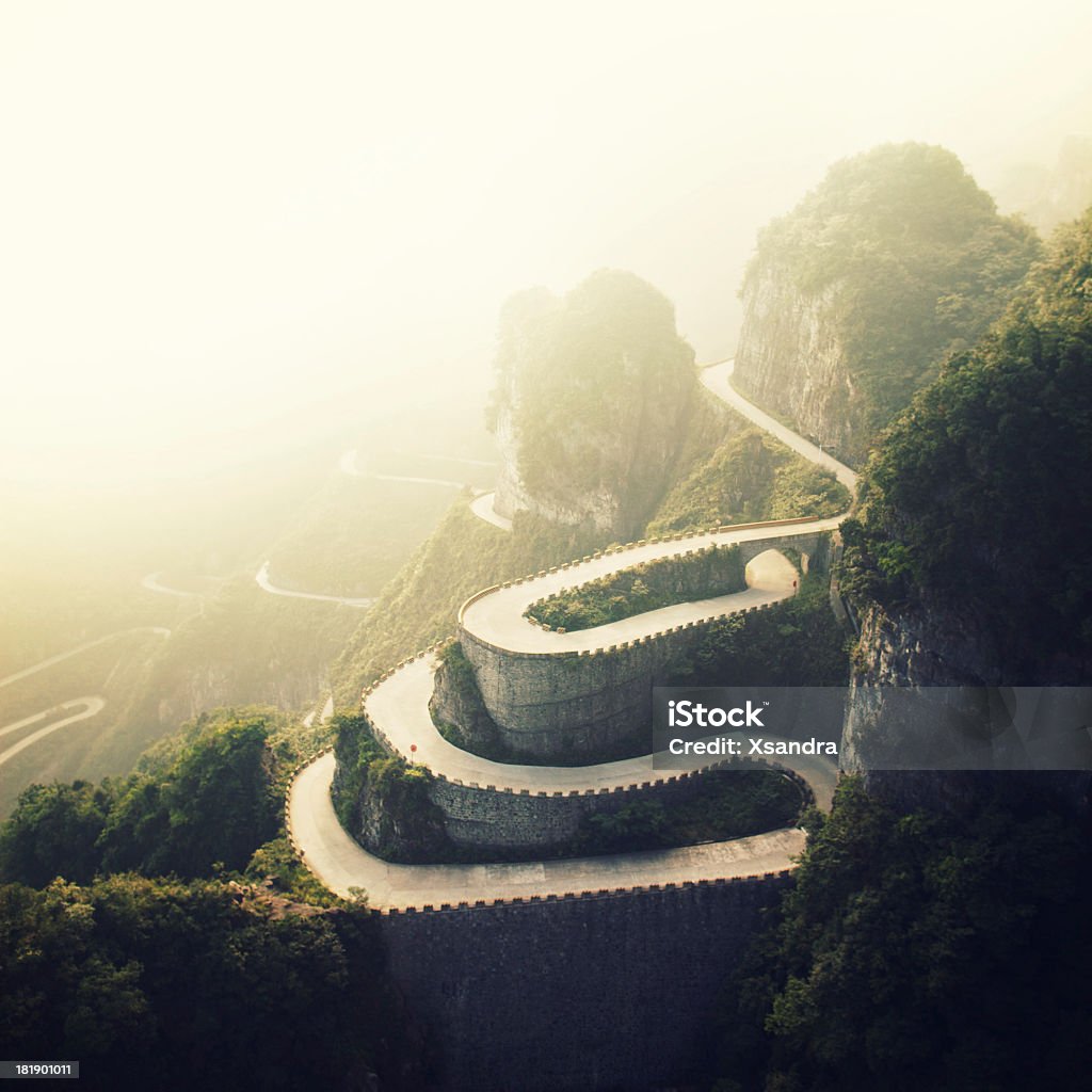 Tianmenshan Landscapes "Top view of winding road in the mountains.Shot taken in Tianmenshan NP, China" Winding Road Stock Photo