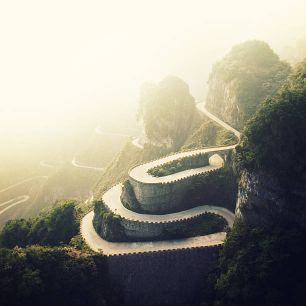 Tianmenshan Landscapes "Top view of winding road in the mountains.Shot taken in Tianmenshan NP, China" winding road mountain stock pictures, royalty-free photos & images