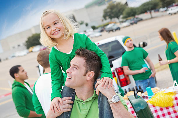 Dad and daughter at college football stadium tailgate party Dad and daughter at college football stadium tailgate party. people family tailgate party outdoors stock pictures, royalty-free photos & images