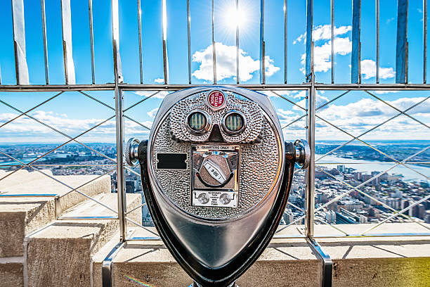 Binoculars, New York City Skyline Empire State Building "Binoculars and spectacular view over New York City, as seen from the Empire State Building observation deck, one of the main tourist attractions in New York City. New York, USA." observation point stock pictures, royalty-free photos & images