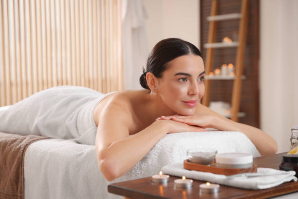 istock Young woman resting on massage couch in spa salon 1819011612