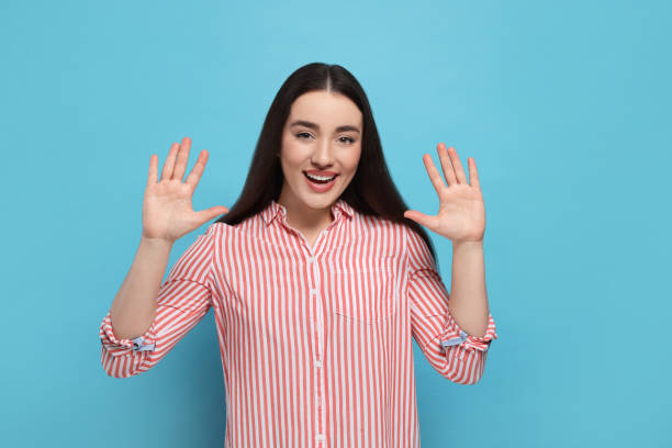 istock Happy woman giving high five with both hands on light blue background 1819013974