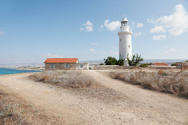 Old white lighthouse over blue sky near Paphos city Cyprus