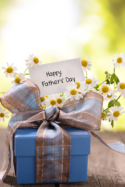 istock Gift box and daisy flowers with a fathers day card 181902136