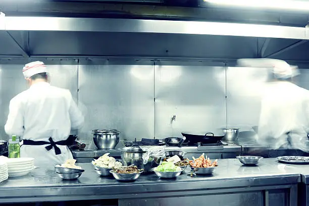 Photo of motion chefs of a restaurant kitchen