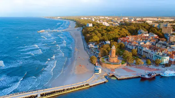 Port and lighthouse in Kolobrzeg, Poland. Photo taken with a drone at the beginning of autumn. The rippling, blue Baltic Sea.