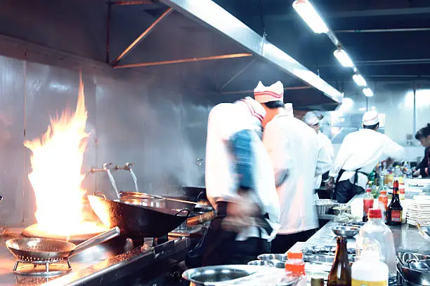 Photo of motion chefs of a restaurant kitchen