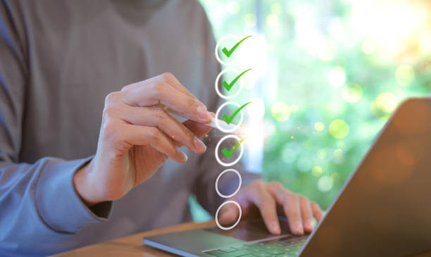 istock Man using pen to tick correct sign mark in checkbox for quality document control checklist and business approve project concept. Check mark, Filling out digital form, Online exam, Knowledge quiz, 1819041835
