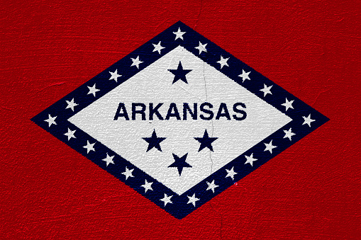 Flag of Arkansas state USA flag on a textured background. Concept collage.