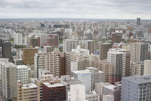Sapporo, Japan - May 30, 2023: View looking southeast from the Sapporo TV Tower. Residential buildings fill Chuo Ward near the Toyohira River. Spring morning in Hokkaido Prefecture.