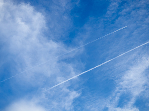 Traces in the sky from airplanes  . Condensation trail. Airplane flight concept. Many lines in the sky.