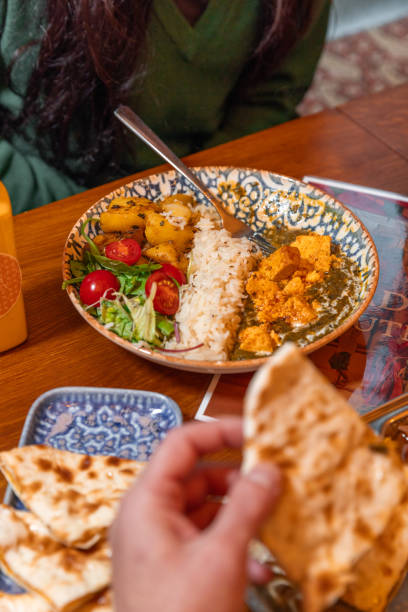 istock Eating Butter Chicken dish with saffron rice on plate at Indian Restaurant 1819239410