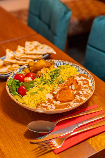 istock Butter Chicken dish with saffron rice on plate at Indian Restaurant 1819256200