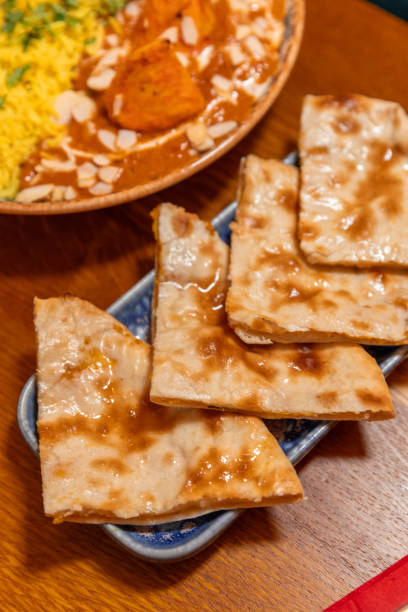 istock Cheese naan bread with Butter Chicken dish in Indian Restaurant 1819256337