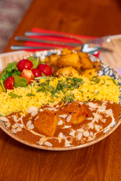 istock Butter Chicken dish with saffron rice on plate at Indian Restaurant 1819257790