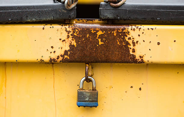 yellow locked dumpster stock photo