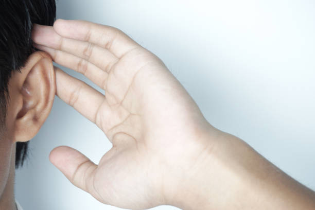 istock Cropped view of man touching ear while listening isolated on white 1819284886
