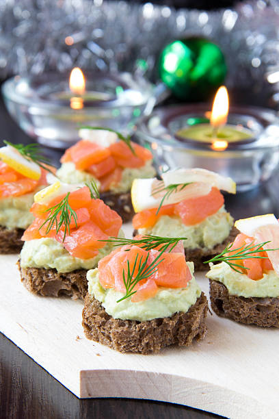 istock Appetizer canapes of bread with avocado, red fish salmon, lemon 181928890