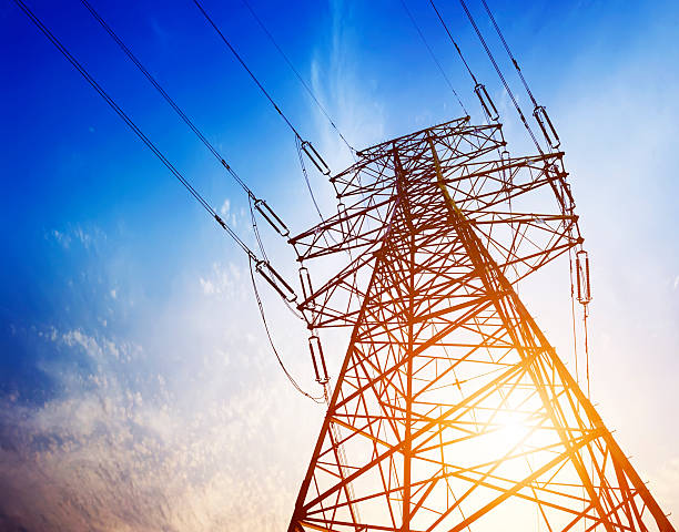 istock Skyward view of high voltage tower under blue sky 181929336