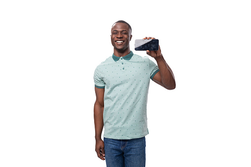 young african man dressed casually showing smartphone screen with mockup standing on white background with copy space.