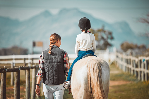 Teenage cowgirl on her horse