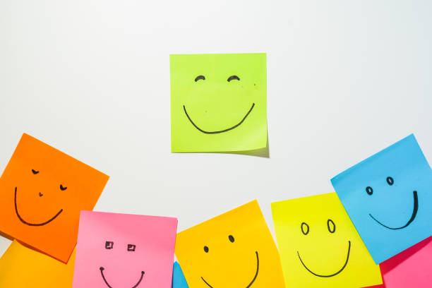 istock Emoji with a cheerful emotion, smile icon on sticky notes 1819344646