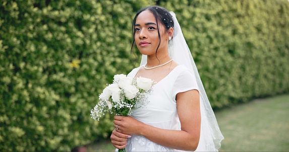 Wedding in garden, portrait of bride with bouquet of roses and smile for celebration of love, future and commitment. Outdoor marriage ceremony, excited and happy woman with flowers, nature and beauty
