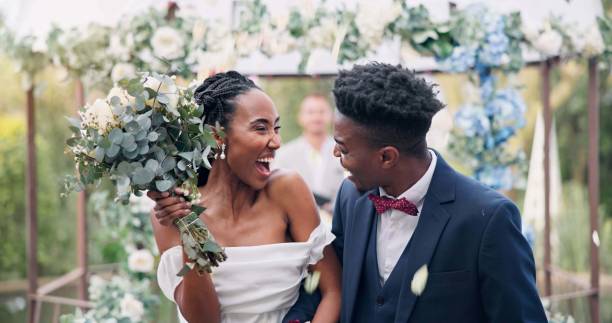 Couple, flower confetti and outdoor wedding with event, walk and happy laugh in nature. Black woman, man and excited for marriage, floral bouquet or holding hands in park, party or together in aisle Couple, flower confetti and outdoor wedding with event, walk and happy laugh in nature. Black woman, man and excited for marriage, floral bouquet or holding hands in park, party or together in aisle marriage black stock pictures, royalty-free photos & images