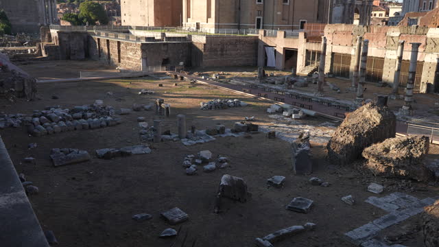 Closeup tracking view of Roman Forum, forum of Julius Caesar with ruins of temple of Venus ancestress in center on sunny day. Concept of vacations