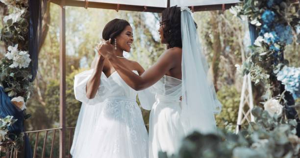 Lesbian, wedding and dance in garden for celebration or love for diversity or commitment, outside and dress. Black women, married and happy with trust for event or romance, ceremony for partnership