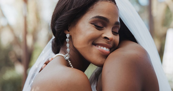 Lesbian, marriage and couple hug at wedding for commitment, love celebration and ceremony. Relationship, African and women dance for lgbt, queer and gay romance for connection, care and bonding