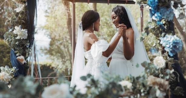 istock Lesbian, wedding and dance in garden for celebration or love for diversity or commitment, outside and dress. Black women, married and happy with trust for event or romance, ceremony for partnership 1819395940