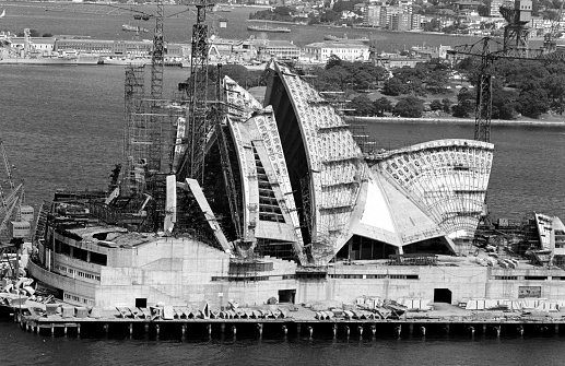Sydney, Australia - April 6, 1966: Cranes on the Sydney Opera House under construction on Bennelong Point. The Australian icon was completed and opened on the 28th of September 1973 by Queen Elizabeth !!.
