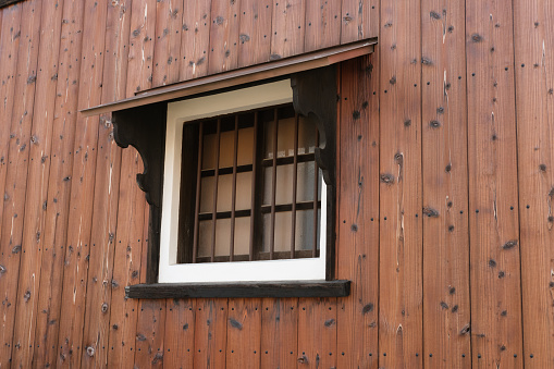 Detail of a half-timbered house with a flower box and balcony plants