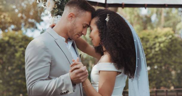 istock Couple, wedding and dancing with touch, countryside and commitment in celebration, love and smile. Interracial marriage, fashion and happy in outdoor, peace and romance of union and trust 1819424673